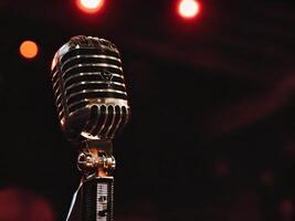 Vintage microphone stands ready for performance under stage lights photo