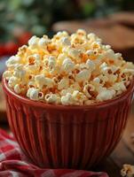 A bowl of popcorn sitting on a table photo