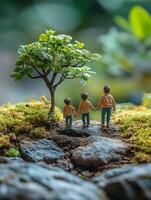 Miniature family tree and family holding hands in the forest photo