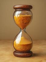 An hourglass with sand on a table photo