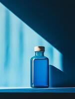 A blue glass bottle sitting on a shelf photo