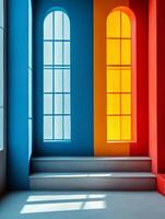 A colorful interior space with blue, orange, and red walls and large arched windows. photo