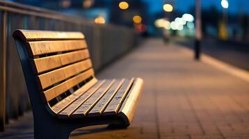 Tranquil Evening Shot of an Empty Wooden Bench on a Lit Urban Sidewalk photo