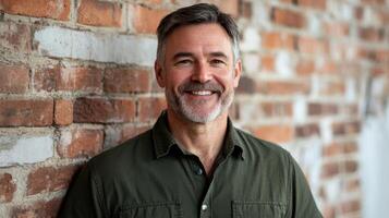 Portrait of a smiling middle-aged man against a textured brick wall background photo
