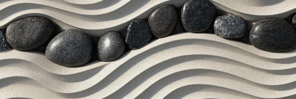 Zen garden with row of smooth black stones on curved sand patterns photo