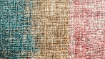 Multicolored textured burlap fabric with red, beige, and blue sections photo