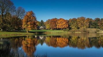 Vibrant autumn landscape with lake reflection and colorful foliage on a clear blue sky day photo