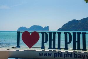 Seaside View with I Love Phi Phi Sign and Limestone Cliffs in Thailand photo