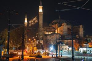 Hagia Sophia Illuminated at Night with Arabic Script Display photo