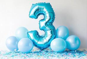 A festive celebration of the third birthday with balloons and confetti in blue pastel tones, an inflatable balloon with the number 3 on a white background photo