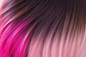 This close-up photo accentuates the vibrant allure of pink hair in an ombre design, revealing a harmonious fusion of colors