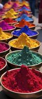 Row of colorful bowls filled with different colored powders. The bowls are arranged in a line, with some bowls closer to the front and others further back. The colors of the powders vary photo
