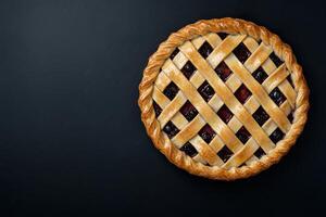 Delicious berry pie with lattice crust on dark background photo