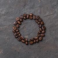 Coffee beans arranged in a circle on a dark background photo