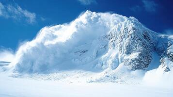 Strong wind blowing snow off mountain peak in winter landscape photo