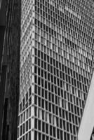 Modern architectural design featuring a grid pattern on a skyscraper in an urban environment captured during daylight photo