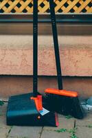 Cleaning tools arranged outside a building on a sunny day ready for use in maintenance work photo