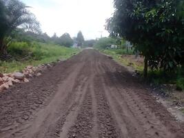 Spreading an aggregate b foundation layer for road construction photo