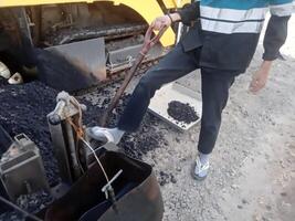 Taking asphalt samples for laboratory testing photo