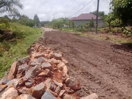 Spreading an aggregate foundation layer for road construction photo