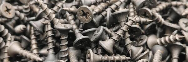 steel self-tapping screws for working with wooden products banner , self-tapping screws for attaching objects to wooden objects, for repair work, hardware store, construction, carpentry, joinery photo