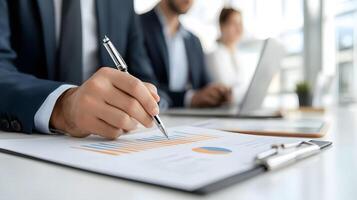 A team of professionals analyzing colorful bar charts and pie graphs during a meeting in a modern conference room photo