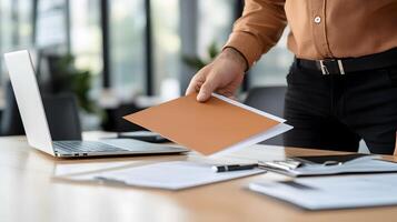 A new employee being shown around the office by a colleague during the onboarding process, with a laptop and documents on the desk photo