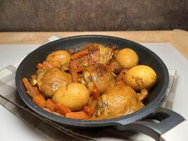 Delicious Asian style chicken or Ayam Kecap with carrots and hard-boiled eggs, served in a black pan. Perfect for recipes, articles, catalogs or any commercial purpose. With copy space. photo