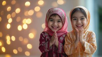 Two smiling girls wearing traditional hijabs photo