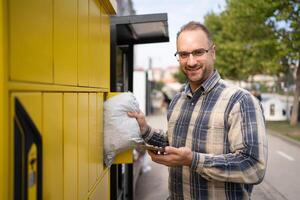 Collecting a package from a smart locker in a vibrant urban setting photo