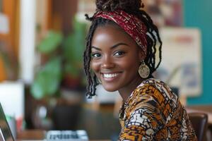 Young woman smiles while working on laptop in vibrant clothing in a market setting during daytime photo