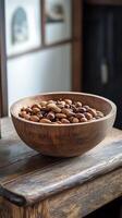 Variety of nuts arranged in a wooden bowl on a rustic table photo