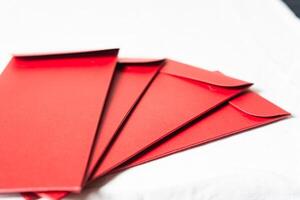 Stack of Red Envelopes on White Surface photo