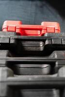 Stacked Toolboxes with a Red Toolbox on Top photo