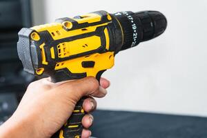 Hand held Yellow and Black Cordless Power Drill photo