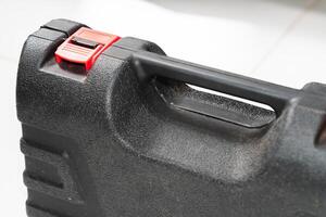 Close-Up of a Black Tool Case with Red Latch photo