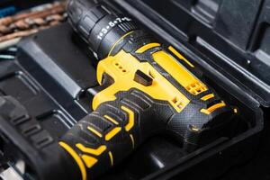 Close-up of a Yellow and Black Cordless Drill in Tool Case photo