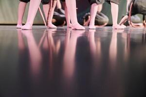 A group of dancers in different poses are standing on the stage. Children performing art on stage. Classical choreography of children, with space to copy photo