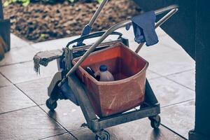 Cleaning in an outdoor cafe before opening. Effective cleaning with a bucket and cleaning products. With space to copy. The concept of maintaining cleanliness photo