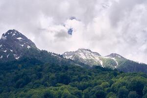 Clouds over the mountains covered with vegetation on a summer day. A period of time. With space to copy photo