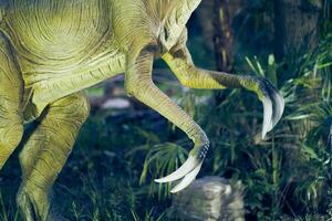 Paws of a predatory dinosaur with hypertrophied claws - therizinosaurus. Part of the body, two paws with claws. There is a place to copy photo