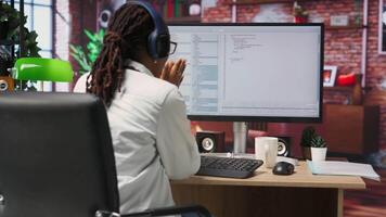 alegre Programas desenvolvedor às computador esperando para código para terminar compilando, a comemorar depois de gerenciando para faço isto corre sem erros. mulher feliz depois de acabamento trabalhos em algoritmo roteiros, Câmera b video