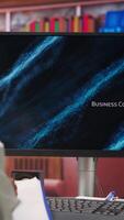 Vertical Remote worker at home watching business conference on PC monitor, looking over statistics on documents. Freelancer in apartment looking at presentation and checking paperwork files, camera B video