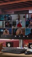 Vertical Employee greeting coworkers during videocall from home desk, organizing calendar appointments. Worker preparing for corporate event, doing remote videoconference meeting with colleagues, camera A video