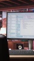 Vertical UI on PC screen in home office with programming code being executed. Coding application UI used by IT programmers to write and test code in modern apartment, panning shot video