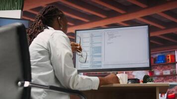 Irked software developer frustrated while coding, struggling to implement algorithms. Unhappy IT expert annoyed while working with code editor, unable to optimize performance, camera B video