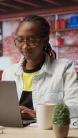 Vertical Woman enjoying leisure time at home, drinking coffee, texting friends on laptop. Cheerful person talking with mates on social network online website, using notebook, camera A video