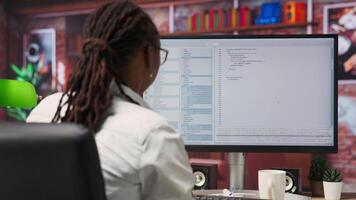 Disappointed engineer in home office looking at UI on computer monitor, failing to properly execute programming code. Displeased IT worker seeing errors while using coding application, camera B video