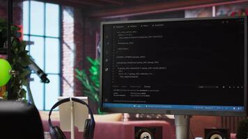 Computer desk with coding application on monitor used for creating software, implementing algorithms. Code editor on PC display used to build applications in cozy bright living room video