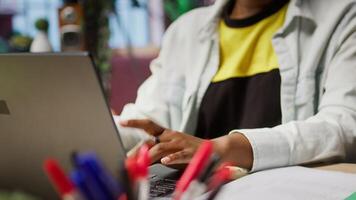 Freelancer in home office sitting at desk and typing on laptop keyboard. Close up of remote worker using electronic device to do customers relations job online, answering inquiries, camera A video